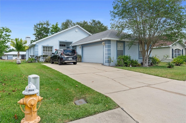 1754 Turtle Rock Dr, Lakeland, FL 33803 - view of front of house with a garage, a front lawn, stucco siding, and concrete driveway