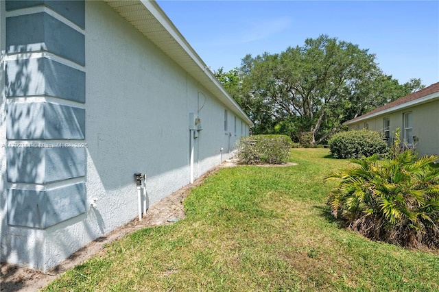 1754 Turtle Rock Dr, Lakeland, FL 33803 - view of side of property featuring a lawn and stucco siding