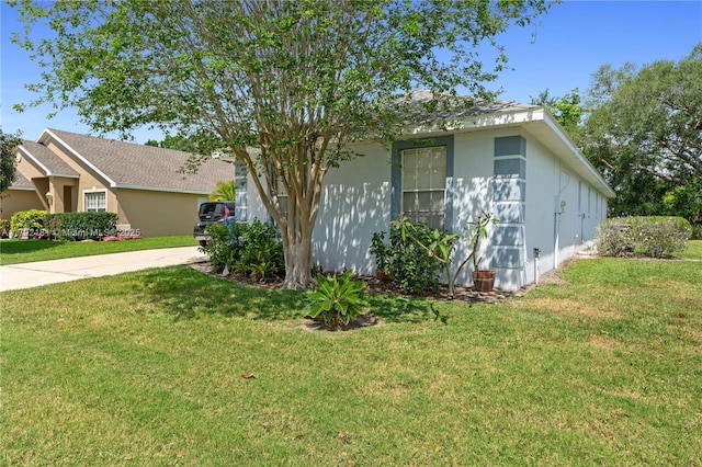 1754 Turtle Rock Dr, Lakeland, FL 33803 - view of front of property with a front lawn, driveway, and stucco siding