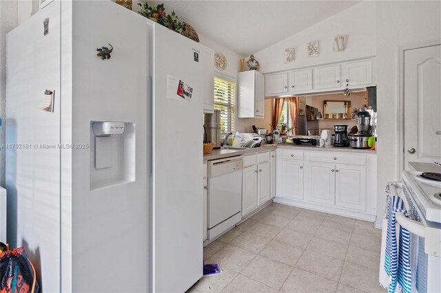 1754 Turtle Rock Dr, Lakeland, FL 33803 - kitchen with light countertops, light tile patterned flooring, white cabinetry, and white appliances