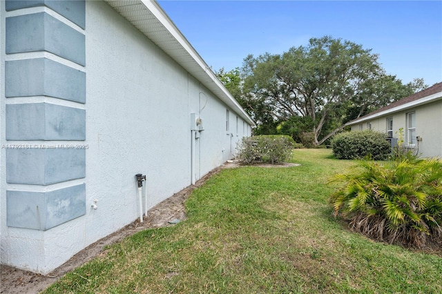 1754 Turtle Rock Dr, Lakeland, FL 33803 - view of side of property with stucco siding and a yard