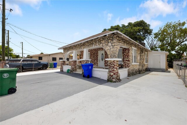 1922 NW 4th St, Miami, FL 33125 - view of front of property with stone siding and fence