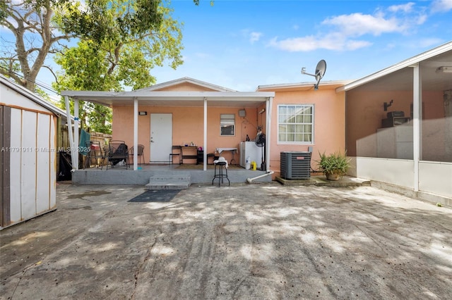 1922 NW 4th St, Miami, FL 33125 - rear view of property with central air condition unit, stucco siding, fence, and a patio