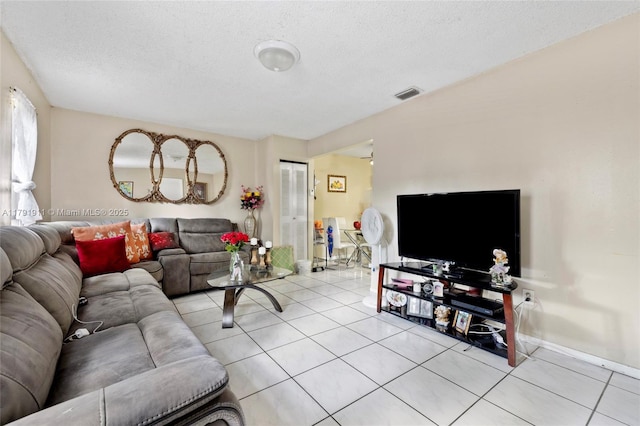 1922 NW 4th St, Miami, FL 33125 - living room with a textured ceiling, baseboards, light tile patterned floors, and visible vents