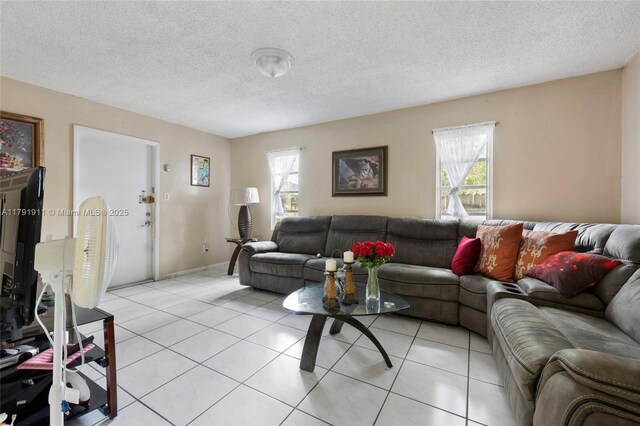 1922 NW 4th St, Miami, FL 33125 - living area with a wealth of natural light, light tile patterned flooring, and a textured ceiling