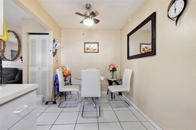 1922 NW 4th St, Miami, FL 33125 - dining area with a ceiling fan, baseboards, light tile patterned flooring, and a textured ceiling