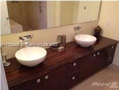 5875 Collins Ave Unit 1006, Miami Beach, FL 33140 - bathroom with double vanity and a sink