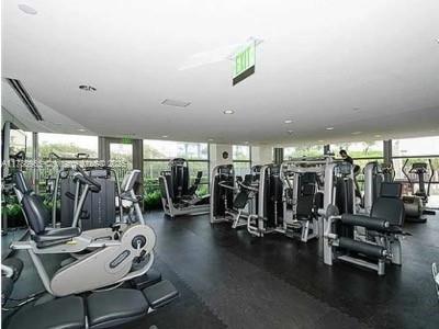 5875 Collins Ave Unit 1006, Miami Beach, FL 33140 - gym featuring a healthy amount of sunlight