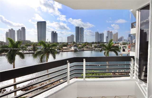 balcony with a view of city and a water view