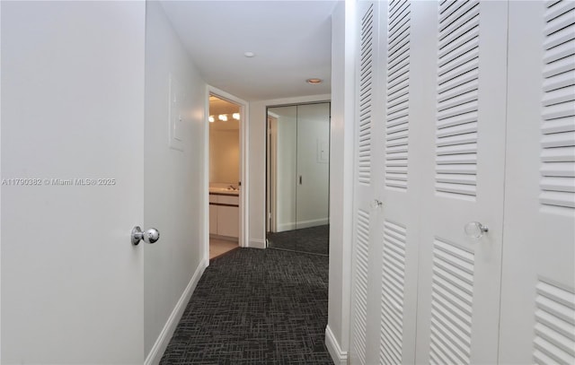 corridor featuring carpet and baseboards