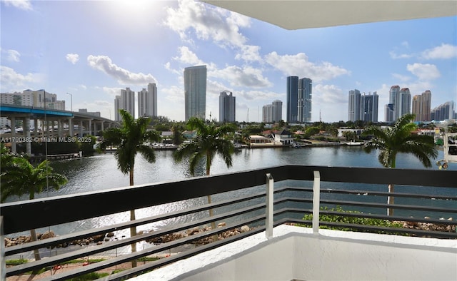 balcony with a view of city and a water view