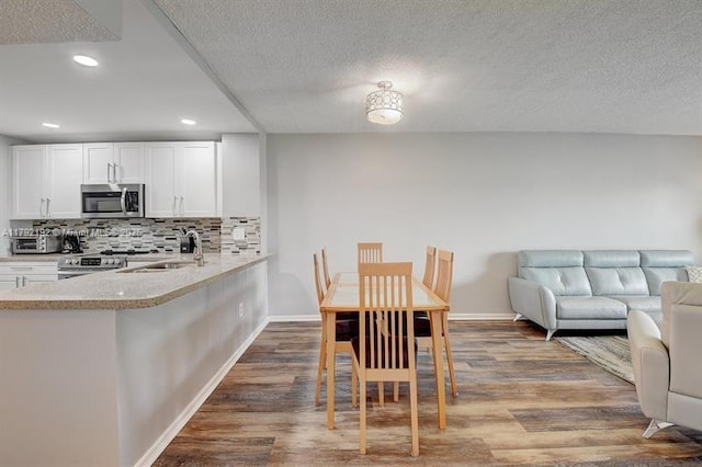 9880 Marina Blvd Unit 1516, Boca Raton, FL 33428 - dining area with a textured ceiling, recessed lighting, and wood finished floors