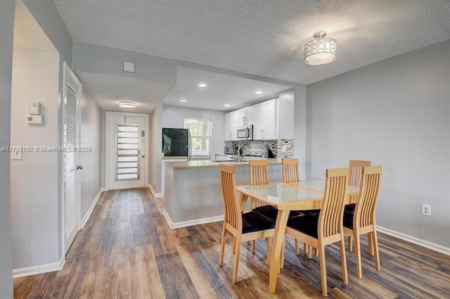 9880 Marina Blvd Unit 1516, Boca Raton, FL 33428 - dining area featuring dark wood-style flooring, a textured ceiling, and baseboards