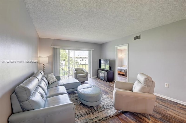 9880 Marina Blvd Unit 1516, Boca Raton, FL 33428 - living area featuring a textured ceiling, baseboards, wood finished floors, and visible vents