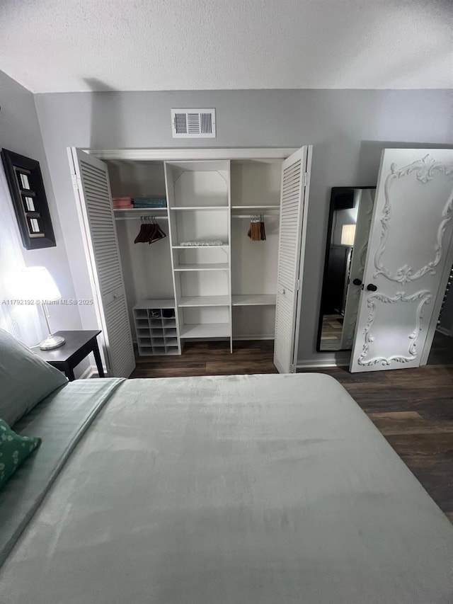 9880 Marina Blvd Unit 1516, Boca Raton, FL 33428 - bedroom featuring dark wood-type flooring, a textured ceiling, and visible vents