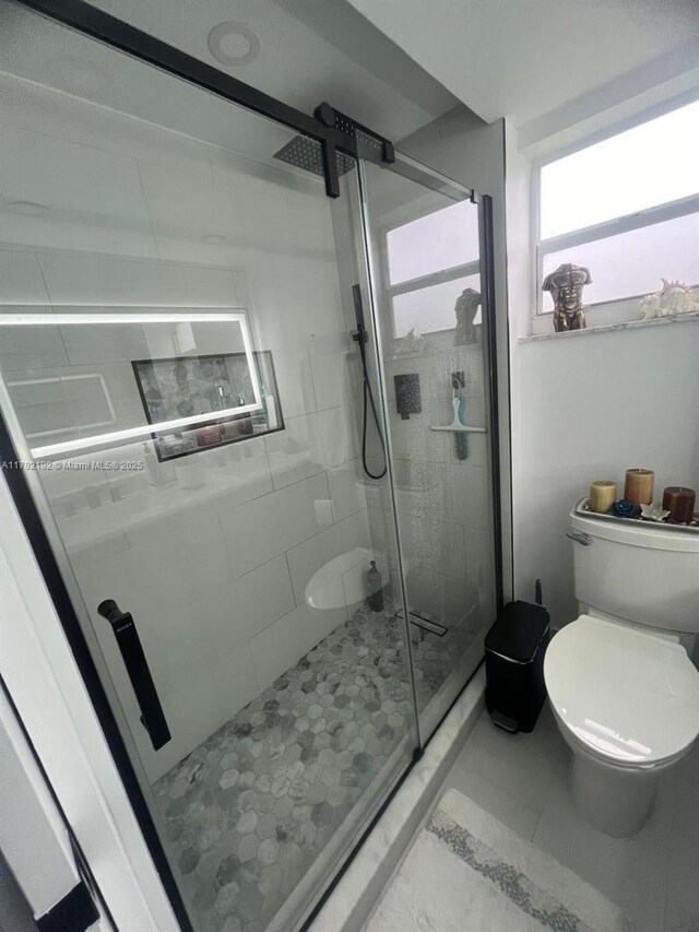 9880 Marina Blvd Unit 1516, Boca Raton, FL 33428 - bathroom featuring tile patterned floors, toilet, and a shower stall