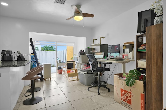 office area featuring visible vents, light tile patterned floors, and a ceiling fan