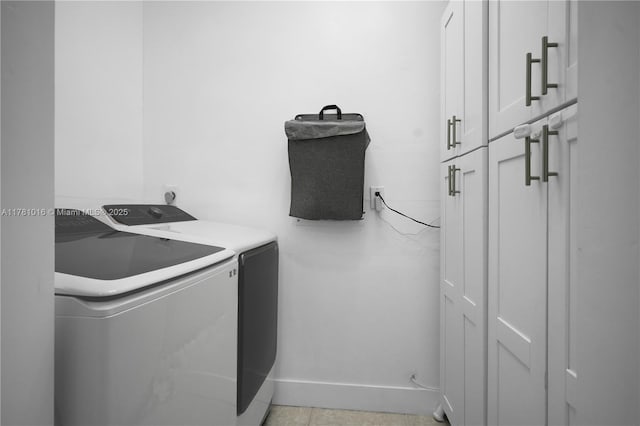 washroom with cabinet space and washing machine and dryer