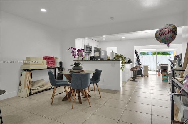 dining area with light tile patterned floors and recessed lighting
