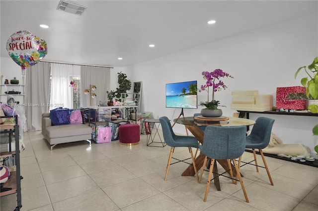 tiled dining space with recessed lighting and visible vents