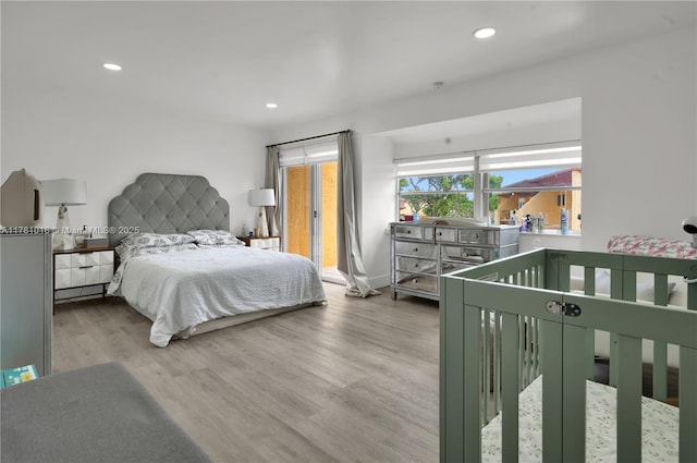 bedroom with wood finished floors and recessed lighting