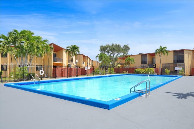 pool with fence and a residential view