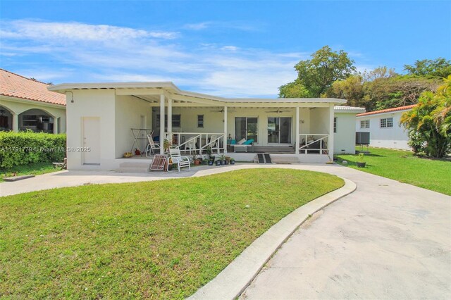 1025 Hunting Lodge Dr, Miami Springs, FL 33166 - rear view of property with a lawn, stucco siding, and central air condition unit