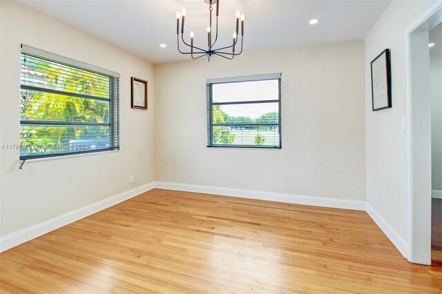 1025 Hunting Lodge Dr, Miami Springs, FL 33166 - unfurnished room featuring plenty of natural light, light wood-type flooring, a chandelier, and recessed lighting