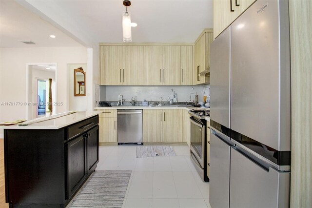 1025 Hunting Lodge Dr, Miami Springs, FL 33166 - kitchen featuring stainless steel appliances, light brown cabinetry, light countertops, light tile patterned flooring, and recessed lighting