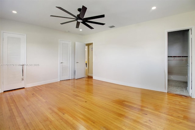 1025 Hunting Lodge Dr, Miami Springs, FL 33166 - unfurnished bedroom featuring light wood-style floors, recessed lighting, two closets, baseboards, and ensuite bathroom