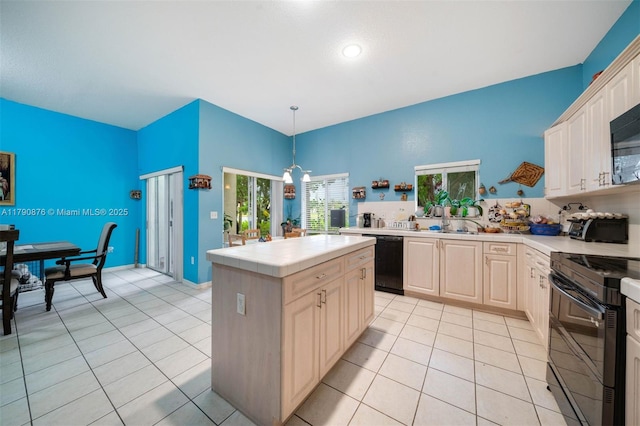 kitchen featuring tile counters, a center island, black appliances, light tile patterned flooring, and decorative light fixtures