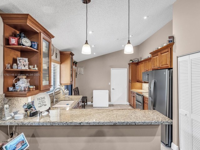 701 SW 113th Ave, Pembroke Pines, FL 33025 - kitchen with stainless steel fridge, a sink, lofted ceiling, a textured ceiling, and light stone counters