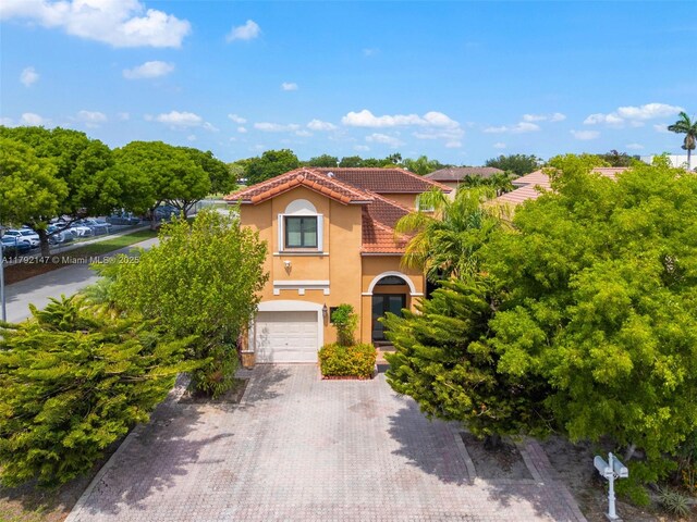 19404 NW 79th Ct, Hialeah, FL 33015 - mediterranean / spanish home with stucco siding, a tile roof, a garage, and decorative driveway