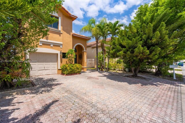 19404 NW 79th Ct, Hialeah, FL 33015 - view of front of home with stucco siding, an attached garage, decorative driveway, and a tiled roof