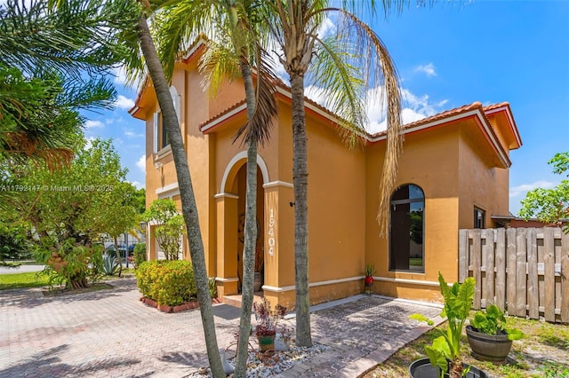 19404 NW 79th Ct, Hialeah, FL 33015 - view of side of home featuring stucco siding and a tiled roof