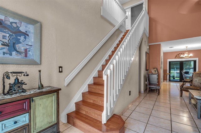 19404 NW 79th Ct, Hialeah, FL 33015 - stairs with tile patterned floors, a chandelier, a towering ceiling, and baseboards