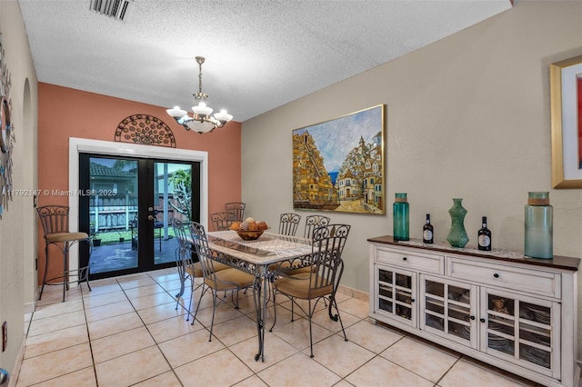 19404 NW 79th Ct, Hialeah, FL 33015 - dining area featuring a textured ceiling, a chandelier, light tile patterned floors, french doors, and baseboards