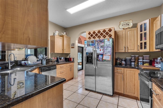 19404 NW 79th Ct, Hialeah, FL 33015 - kitchen with stainless steel appliances, light brown cabinets, a sink, arched walkways, and light tile patterned floors