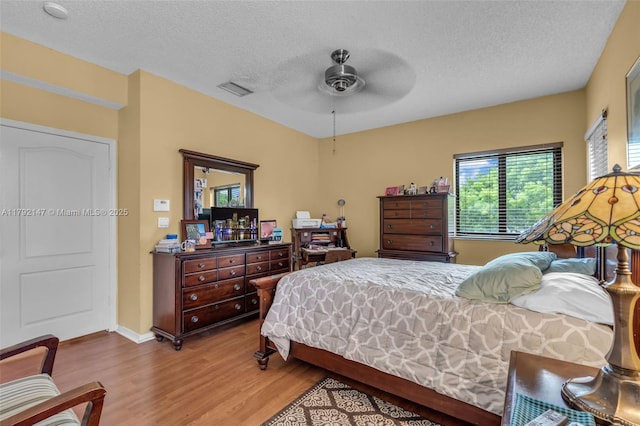 19404 NW 79th Ct, Hialeah, FL 33015 - bedroom featuring wood finished floors, a textured ceiling, baseboards, and a ceiling fan
