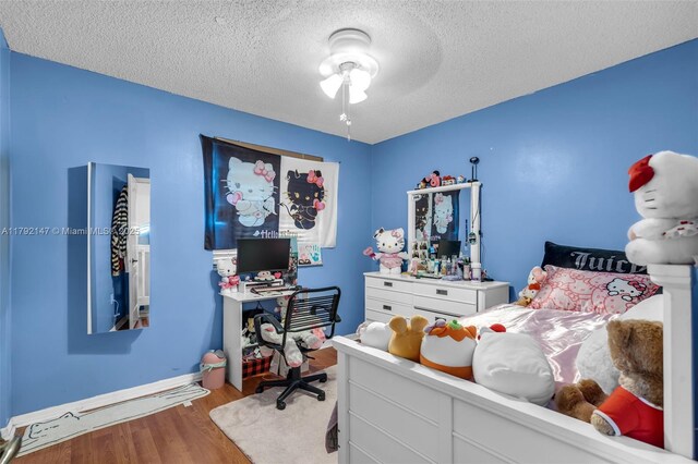19404 NW 79th Ct, Hialeah, FL 33015 - bedroom with a textured ceiling, wood finished floors, baseboards, and ceiling fan