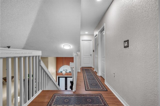 19404 NW 79th Ct, Hialeah, FL 33015 - corridor featuring a textured wall, wood finished floors, an upstairs landing, baseboards, and recessed lighting