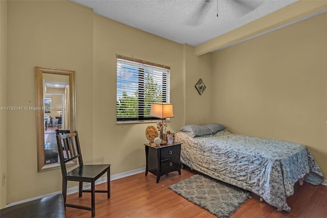 19404 NW 79th Ct, Hialeah, FL 33015 - bedroom featuring wood finished floors, a textured ceiling, and baseboards
