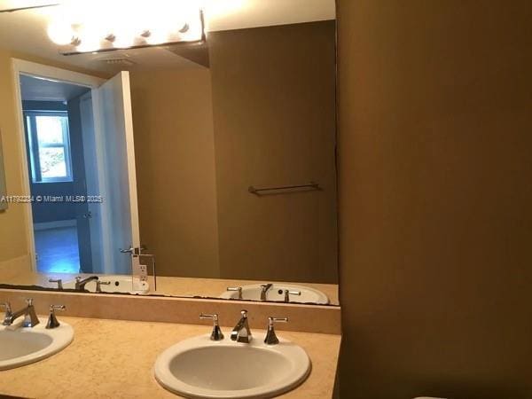 bathroom with double vanity and a sink