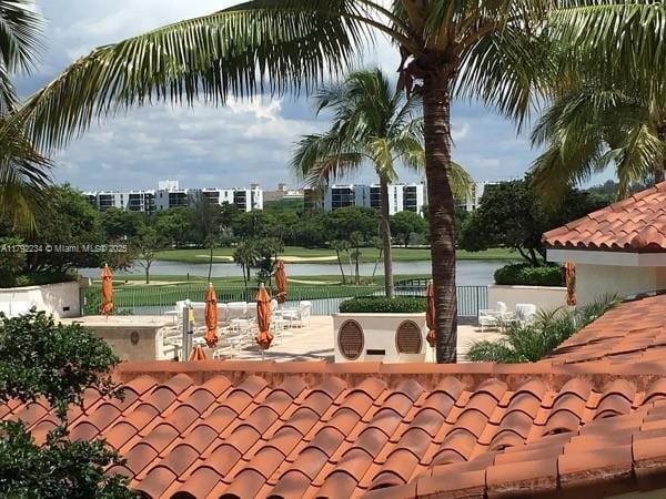 view of home's community featuring a water view, ac unit, and fence