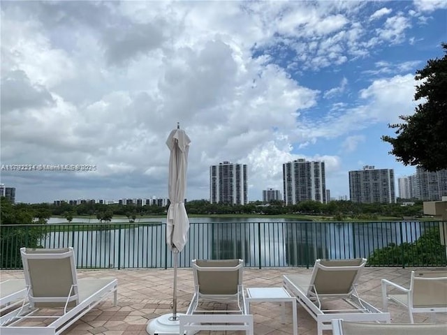 view of patio featuring a city view and a water view