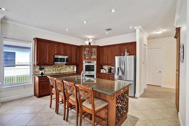 19323 SW 55th St, Miramar, FL 33029 - kitchen featuring tasteful backsplash, a sink, light tile patterned floors, a breakfast bar, and stainless steel appliances