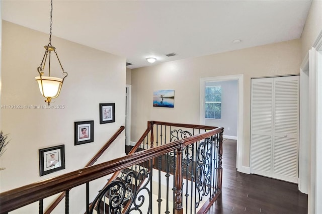19323 SW 55th St, Miramar, FL 33029 - hallway featuring visible vents, baseboards, dark wood-style floors, and an upstairs landing