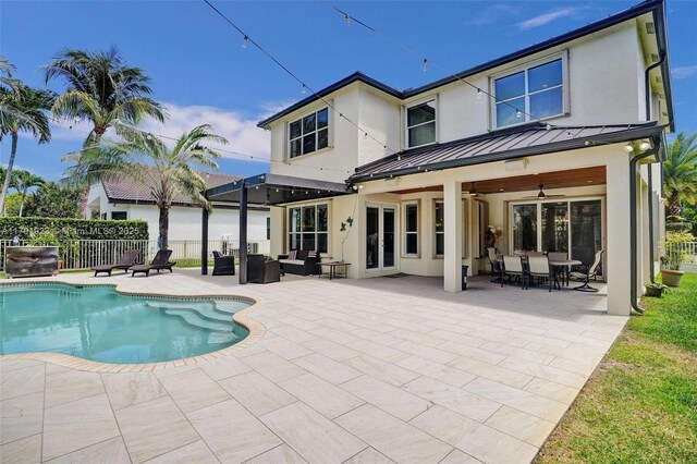 19323 SW 55th St, Miramar, FL 33029 - rear view of house with fence, stucco siding, a standing seam roof, a fenced in pool, and a ceiling fan