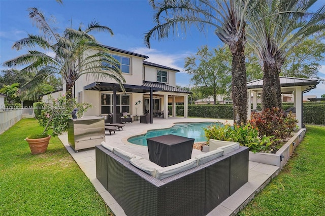19323 SW 55th St, Miramar, FL 33029 - rear view of house with stucco siding, outdoor lounge area, a fenced backyard, a standing seam roof, and a lawn