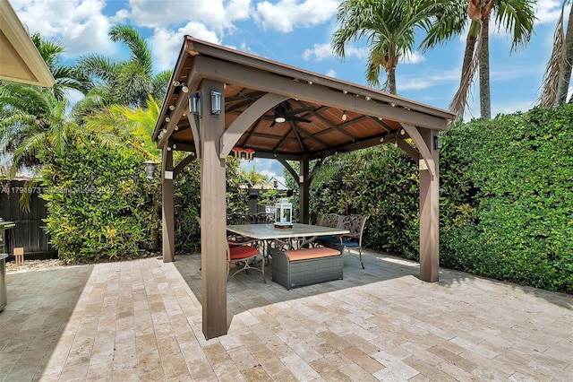 view of patio featuring a gazebo, a fenced backyard, and outdoor dining area